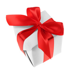Gift box with red ribbon isolated on white