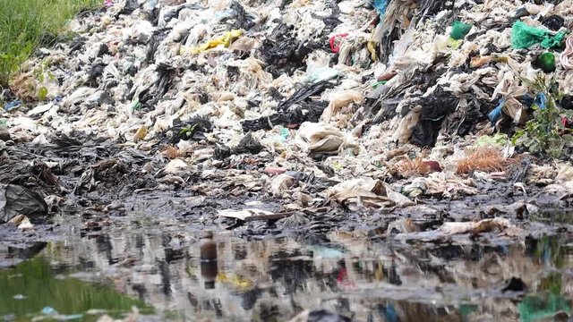 Garbage on Landfill Site Pollute River and Damage Environment