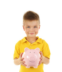 Savings concept. Cute boy in yellow T-shirt holding piggy bank isolated on white