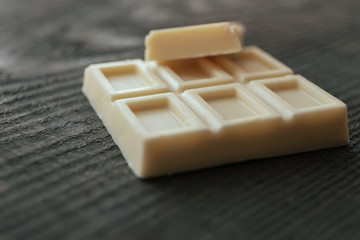Pile of white chocolate bars on old wooden background
