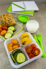 Healthy vegetarian food in plastic lunch box on light background.
