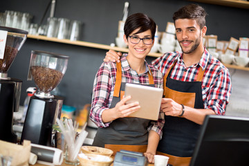 Satisfied owners look orders coffee shop