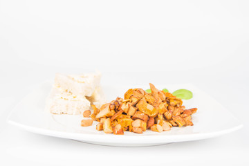 Sauteed chanterelle with garlic and some white bread on a plate decorated with basil