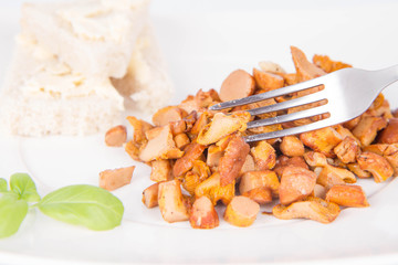 Sauteed chanterelle with garlic and some white bread eaten with a fork