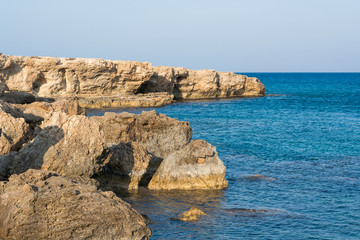 Fototapeta na wymiar Sea coast, rocky bay in a quiet sunny day.