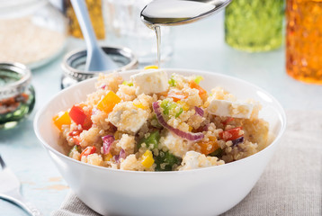 Close up of quinoa salad on blue old wooden table