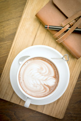 Coffee cup and notebook