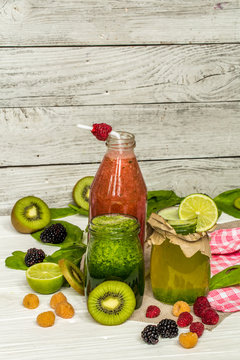 green and red smoothies in a jar with lime, kiwi