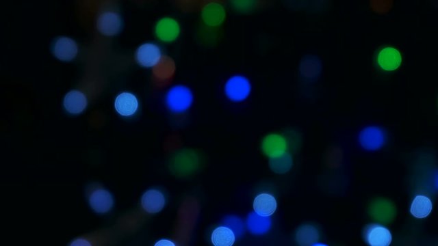 Blue, green, red, colorful blurred, bokeh lights background. Abstract sparkles. Christmas garlands, 4k