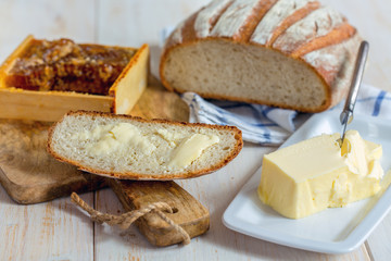 Piece of bread with butter close up.