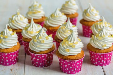 Lemon cupcakes with meringue and candied fruits.