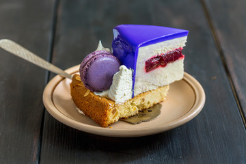 Piece of cake with blackberries and macarons,