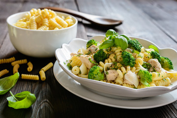 Pasta salad with chicken meat, broccoli, cheese and basil
