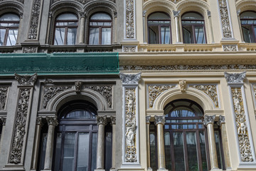 Fototapeta na wymiar Detail of architectural building facade with windows. Interestin