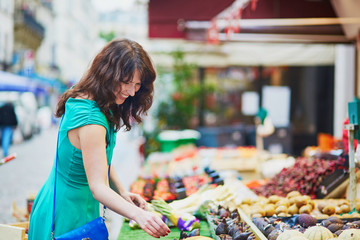 French woman choosing fruits on market