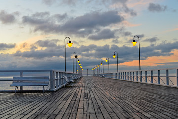Beautiful wooden pier at sunrise