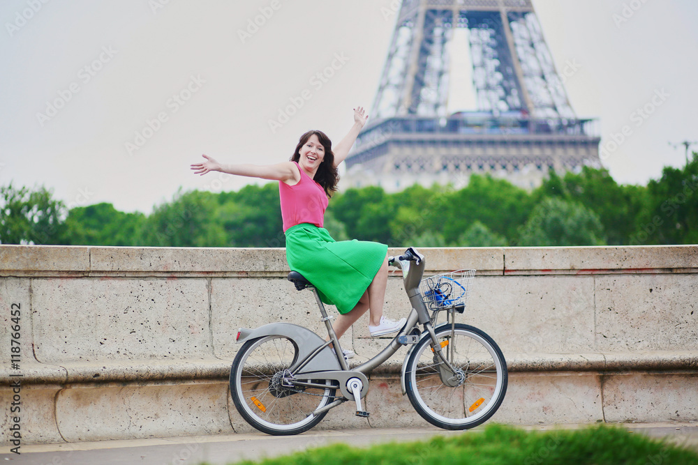 Wall mural Woman riding a bicycle on a street of Paris