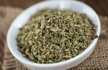 Old wooden table with dried Stevia leaves (selective focus)