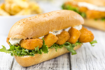 Roll with fried Fish Sticks (close-up shot)