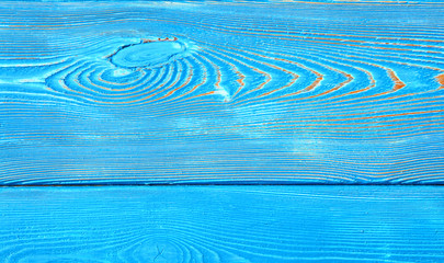 Closeup image of bumpy wooden wall background painted blue
