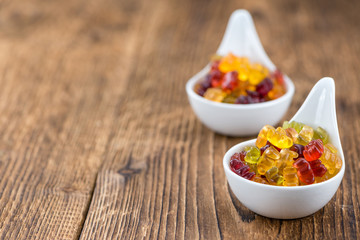 Wooden table with Gummy Bears (selective focus)