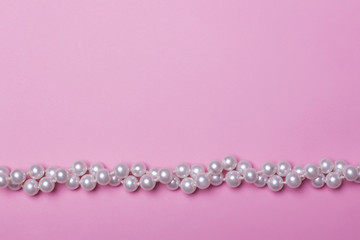 Obraz premium Pearls on pink background.
