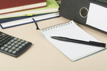 Home savings, budget concept. Chart, notepad, pen, calculator and coins on wooden office desk table.