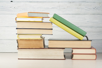 Open book, hardback books on wooden table. Education background. Back to school. Copy space for text.