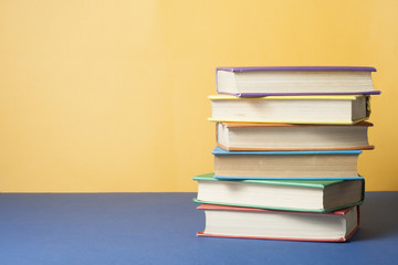 Stack of colorful books. Education background. Back to school. Copy space for text.