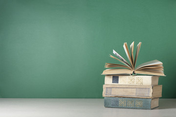 Open book, hardback books on wooden table. Education background. Back to school. Copy space for text.