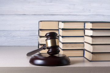 Law concept - Book with wooden judges gavel on table in a courtroom or enforcement office.