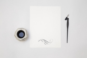 white blank paper sheet mockup with calligraphy nib and ink