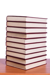 Stack of books arranged the office desk