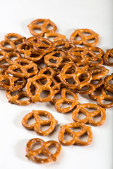 heap of mini pretzels, isolated on a white background, close up, vertical