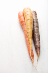 carrots in colors white cutting board with copyspace