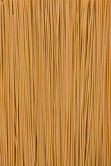 brown color, gluten free spaghetti made with quinoa and brown rice, background, close-up, top view, vertical