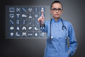 Woman doctor pressing buttons with various medical icons