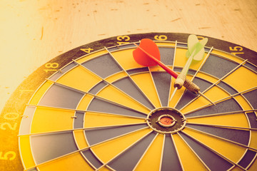 Red and green darts arrow on dartboard. Business, financial and marketing competition or game concept.