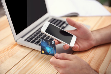 Man hands using credit card and phone for online shopping