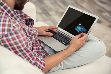 Man hands using credit card and laptop for online shopping