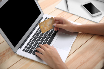 Fototapeta premium Woman hands using credit card and laptop for online shopping