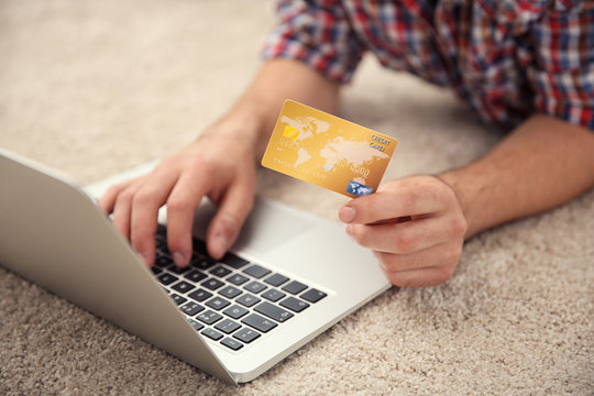 Man hands using credit card and laptop for online shopping