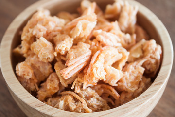Fried shrimp chins snack in wooden bowl