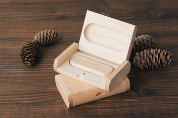 Wooden box with usb stick on dark wooden background. Packaging for USB drives. Two boxes with...