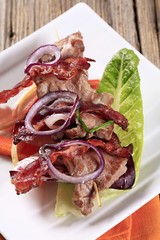Roast meat on skewer with crispy bacon