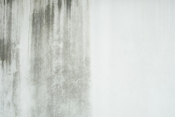 old, dirty, broken white concrete wall with black stain background texture.