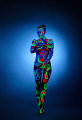 Obraz na płótnie Canvas Erotica in ultraviolet light. Nude girl posing
