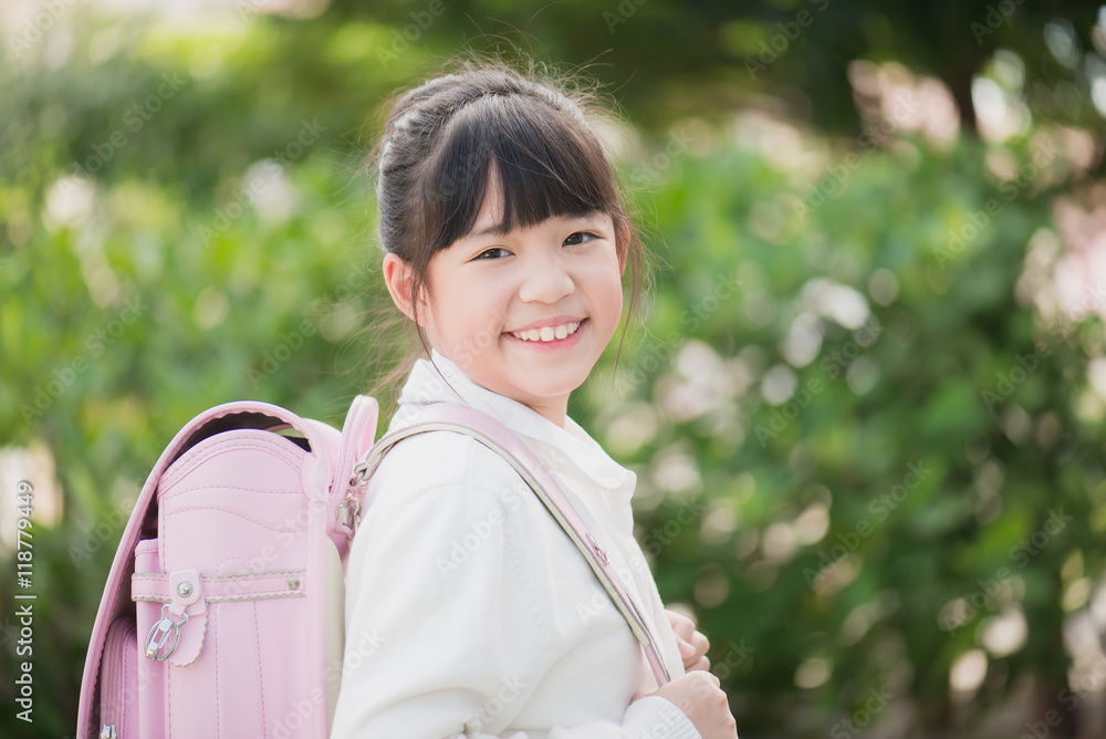 Wall mural Asian school girl with pink backpack