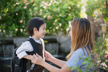 mother  saying goodbye to her son as he leave for School