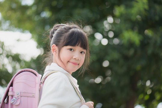 Asian school girl with pink backpack
